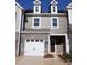 Two-story townhome with gray siding, white garage door, and stone accents at 4031 Lawnview Dr, Charlotte, NC 28269