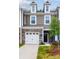 Charming two-story home features stone accents, attached garage, and welcoming entryway at 4031 Lawnview Dr, Charlotte, NC 28269