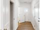 Hallway with wooden floors and white doors creating a neat modern feel at 4031 Lawnview Dr, Charlotte, NC 28269