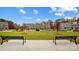 View of townhomes surrounding a well-manicured common area with benches at 5544 Stafford Rd # 30, Charlotte, NC 28215