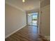 Cozy dining area with hardwood floors, a stylish light fixture, and a sliding glass door to the outside at 5544 Stafford Rd # 30, Charlotte, NC 28215