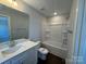 A well lit bathroom featuring a shower-tub, vanity, toilet, and mirror at 5548 Stafford Rd # 29, Charlotte, NC 28215