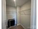 Walk-in closet with shelving and neutral carpet at 5548 Stafford Rd # 29, Charlotte, NC 28215