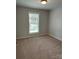 Cozy bedroom with neutral carpet, a large window, and ample natural light creating a peaceful retreat at 718 Park Ave, Salisbury, NC 28144