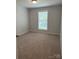 Bright bedroom with neutral carpet and a large window providing a peaceful retreat for relaxation and rest at 718 Park Ave, Salisbury, NC 28144