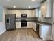 A modern kitchen boasts stainless appliances, granite countertops, and sleek white cabinetry, flooded with natural light at 718 Park Ave, Salisbury, NC 28144