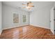 Well-lit bedroom with hardwood floors and ceiling fan at 800 Lakeview Shores Loop, Mooresville, NC 28117