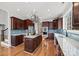 Eat-in kitchen with dark wood cabinets, granite countertops, and stainless steel appliances at 800 Lakeview Shores Loop, Mooresville, NC 28117