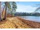 Sandy lakefront with red chairs and fall leaves at 800 Lakeview Shores Loop, Mooresville, NC 28117