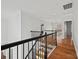 Upstairs hallway with hardwood floors and elegant iron railings at 800 Lakeview Shores Loop, Mooresville, NC 28117