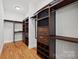 Large walk-in closet with custom shelving and drawers at 800 Lakeview Shores Loop, Mooresville, NC 28117