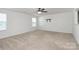 Well-lit bedroom with plush carpeting, ceiling fan, and ample natural light from the windows at 980 Von Buren Blvd, Rock Hill, SC 29730