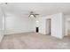 Spacious bedroom featuring a ceiling fan, plush carpet, and an adjoining bathroom at 980 Von Buren Blvd, Rock Hill, SC 29730