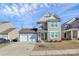 Attractive two-story home with a stone-accented facade, two-car garage, and tidy landscaping at 980 Von Buren Blvd, Rock Hill, SC 29730