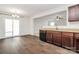 Open kitchen layout with dark wood cabinets, granite countertops, and a view of the adjacent dining area at 980 Von Buren Blvd, Rock Hill, SC 29730