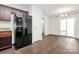 Spacious kitchen area with dark wood cabinets, a black refrigerator, and an open dining space at 980 Von Buren Blvd, Rock Hill, SC 29730