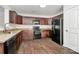 Modern kitchen with dark cabinetry, granite counters, stainless steel sink, and sleek black appliances at 980 Von Buren Blvd, Rock Hill, SC 29730