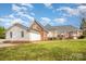 Well-maintained backyard featuring a spacious lawn, mature trees, and tasteful landscaping at 180 Sink Farm Rd, Mooresville, NC 28115