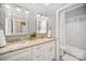 Bright bathroom with granite countertops, dual sinks, and tub with shower at 180 Sink Farm Rd, Mooresville, NC 28115