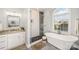 Modern bathroom featuring a glass-enclosed shower, soaking tub, and stylish fixtures at 180 Sink Farm Rd, Mooresville, NC 28115