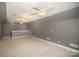 Large bonus room featuring carpet, multiple ceiling fans and natural light at 180 Sink Farm Rd, Mooresville, NC 28115