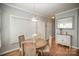Bright dining area featuring hardwood floors and a modern pendant light at 180 Sink Farm Rd, Mooresville, NC 28115