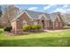 Well-maintained brick home with lush lawn, manicured shrubs, and arched windows at 180 Sink Farm Rd, Mooresville, NC 28115