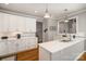 Modern kitchen with white cabinets, countertops and hardwood floors at 180 Sink Farm Rd, Mooresville, NC 28115