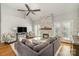 Comfortable living room with stone fireplace, ceiling fan, and hardwood floors at 180 Sink Farm Rd, Mooresville, NC 28115