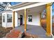 Inviting front porch with stylish wooden columns, brick steps, and a freshly painted floor at 306 S Jones Ave, Rock Hill, SC 29730