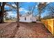 White house with a large backyard covered in autumn leaves at 306 S Jones Ave, Rock Hill, SC 29730
