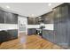 Updated kitchen featuring dark cabinets, stainless steel appliances, and hardwood floors at 306 S Jones Ave, Rock Hill, SC 29730