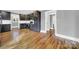 Dark wood cabinets, white backsplash, hardwood floors at 306 S Jones Ave, Rock Hill, SC 29730