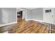 Hardwood floors, gray walls, and view into kitchen at 306 S Jones Ave, Rock Hill, SC 29730