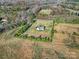 Aerial view of a home with gravel driveway in a large yard surrounded by woods at 3798 Red Doc Rd, Lancaster, SC 29720