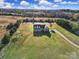 Gorgeous aerial view of a home on beautifully landscaped acreage with lush trees and a long driveway at 3798 Red Doc Rd, Lancaster, SC 29720