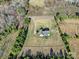 Aerial view of a home with gravel driveway surrounded by trees and grass at 3798 Red Doc Rd, Lancaster, SC 29720