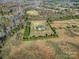 Aerial view of a home surrounded by grass and woods with a gravel driveway at 3798 Red Doc Rd, Lancaster, SC 29720