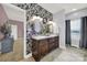 Bathroom with dual sinks, modern lighting, and stylish wallpaper at 3798 Red Doc Rd, Lancaster, SC 29720