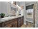 Well-lit bathroom featuring dual sinks with granite counters and a decorative mirror at 3798 Red Doc Rd, Lancaster, SC 29720