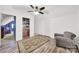 Bright bedroom featuring built-in shelves, wood-look flooring, and a comfortable armchair at 3798 Red Doc Rd, Lancaster, SC 29720