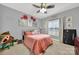 Charming bedroom with a plush bed, a ceiling fan, and whimsical wall decor at 3798 Red Doc Rd, Lancaster, SC 29720