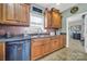 Kitchen features a stainless steel dishwasher, double sink, and traditional cabinetry at 3798 Red Doc Rd, Lancaster, SC 29720