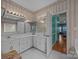 Bathroom with double sinks, large mirrors, and an entrance to main bedroom at 4687 Snow Dr, Harrisburg, NC 28075