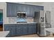 Charming kitchen with blue cabinets, stainless steel appliances, and tile backsplash at 4687 Snow Dr, Harrisburg, NC 28075