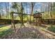 Playset and tree fort in a wooded backyard at 5328 Caradon Dr, Charlotte, NC 28227