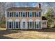 Two-story house with beige siding, green shutters, and a yard at 5328 Caradon Dr, Charlotte, NC 28227