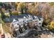 Aerial view of tan and brick townhomes surrounded by fall foliage at 7108 Founders Club Ct, Charlotte, NC 28269