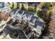 Aerial view of townhomes featuring tan siding, brick foundations, and attached garages at 7108 Founders Club Ct, Charlotte, NC 28269