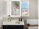 Well-lit bathroom with vanity, illuminated mirror and tub with tile surround at 7108 Founders Club Ct, Charlotte, NC 28269